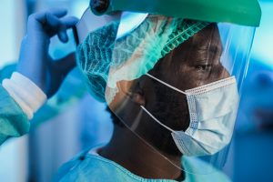 Medical doctors at work inside hospital during coronavirus outbreak - Focus on african man eye